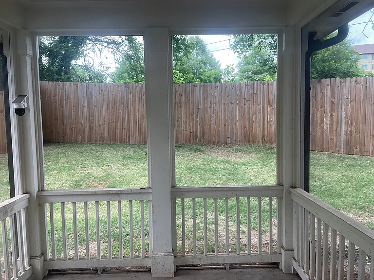 Outdoor back patio with view into fully fenced back yard.
