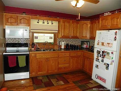 updated kitchen with tile backsplash and under cabinet lighting