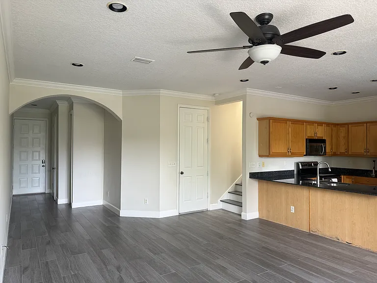 View of entry, stairs, and kitchen
