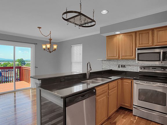 Kitchen with granite and stainless steel appliances that over looks the dining room and deck.