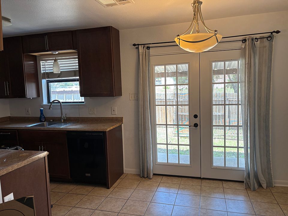 Nice patio doors. Covered porch in backyard with storage shed.