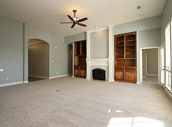Enormous family room open to back covered patio and kitchen. Custom cabinets built-in to accommodate your electronics, pictures and books!