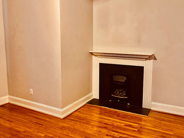 Large bedroom with gas fireplace and private bath with shower and separate clawfoot tub.
