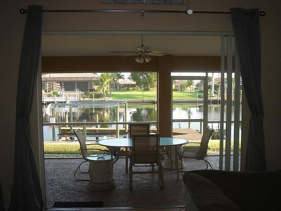 View of lanai and canal from living room