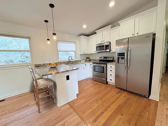 Kitchen with new appliances and eat-in bar.