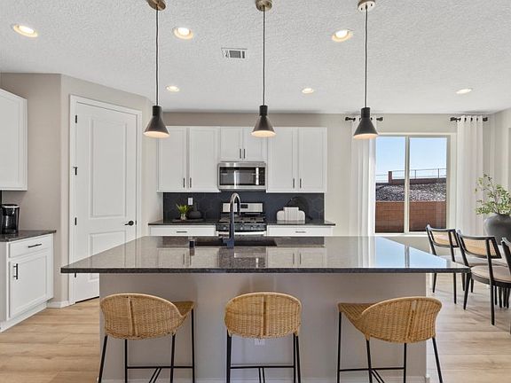Enjoy functionality throughout with a large kitchen island and a spacious corner pantry.