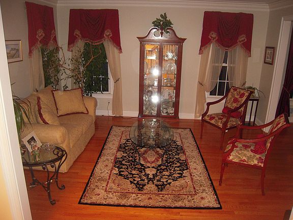 Formal Living room with custom crown molding and hardwood floors