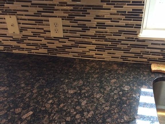 granite and backsplash in kitchen