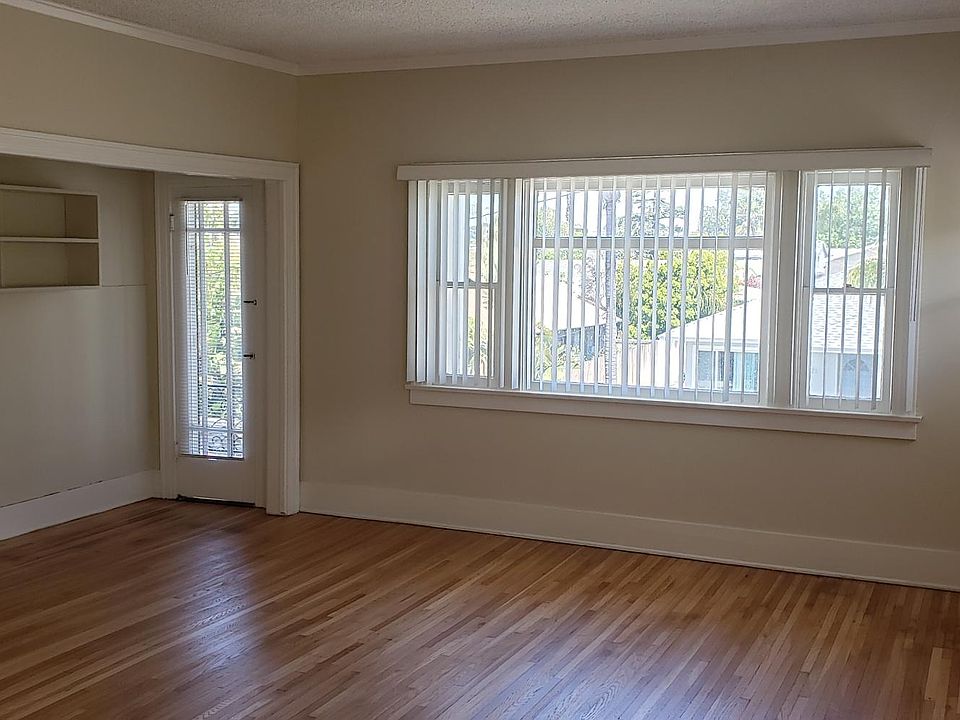 Large living room with office nook area with built-in shelving