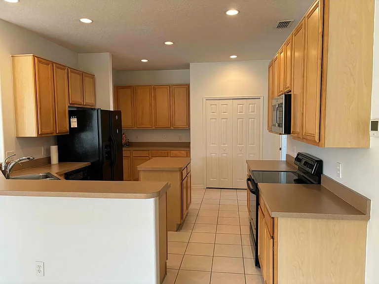 Spacious kitchen with island and abundant cabinet storage space