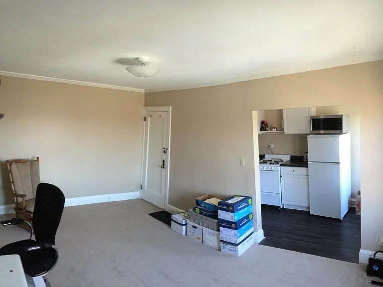 living room toward front door and kitchen #10