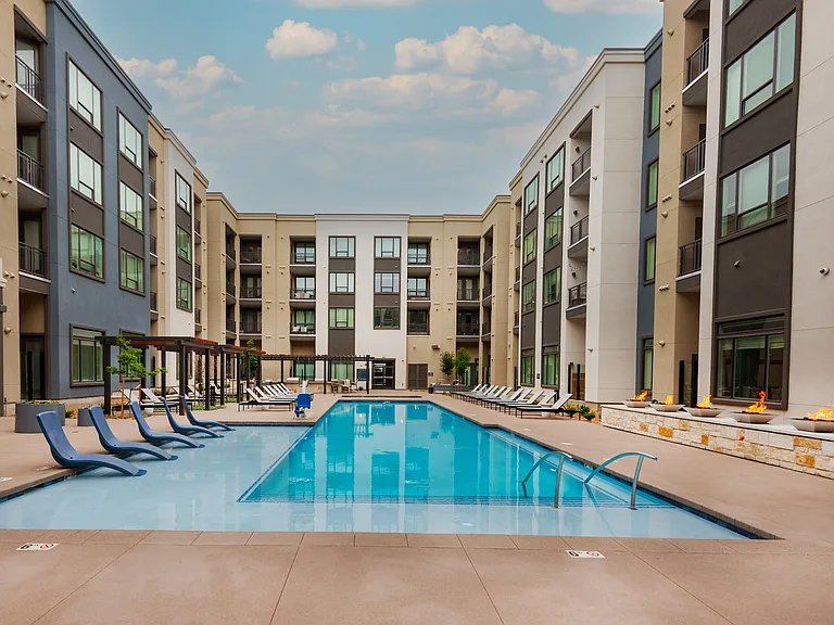 Large Swimming Pool Surrounded by Lounge Chairs