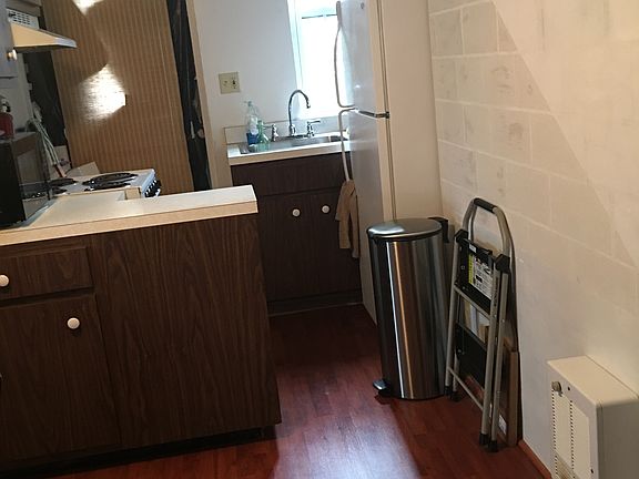 Beautiful accent wall and kitchen area with window and plenty of storage