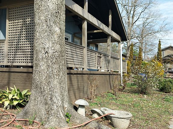 Front of house. Large shade tree on left