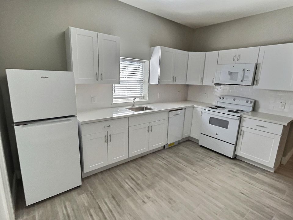 Kitchen with all new appliances, great counter space, and lots of storage space. Refrigerator, dishwasher, microwave, and oven/stove. Also room for small dining table.