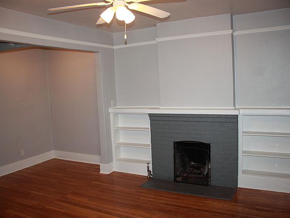 Living room with gas fireplace and built-in shelves