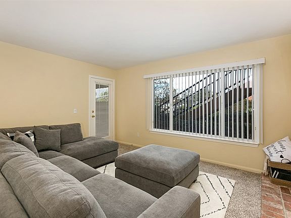 The spacious living room opens to the private patio!