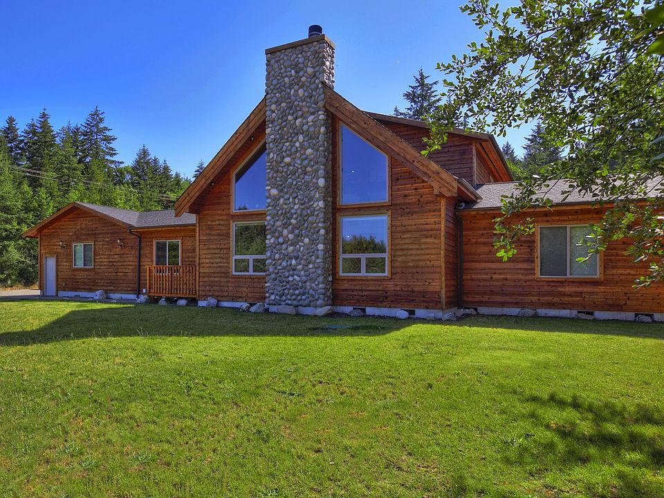 Gorgeous cedar siding with natural stone chimney on nearly 5 acres