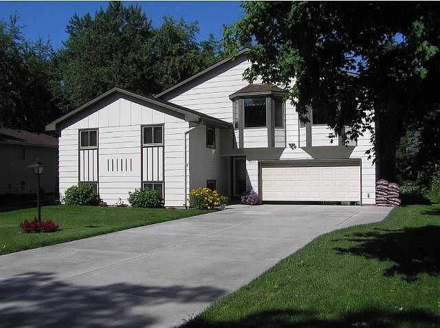 Exceptional home on quiet, tree-lined  street of huge yards. This yard is over 200 feet deep. Fenced back yard. Look at that new and bright concrete driveway installed in 2014.