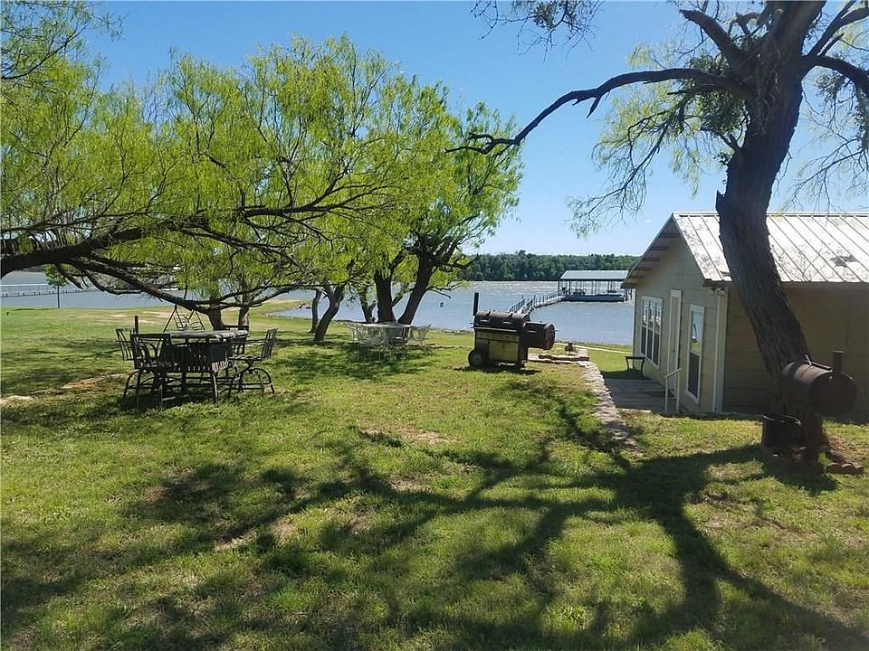 So many possibilities with this lake front home!  Enjoy cooking out in the tree shaded lot!