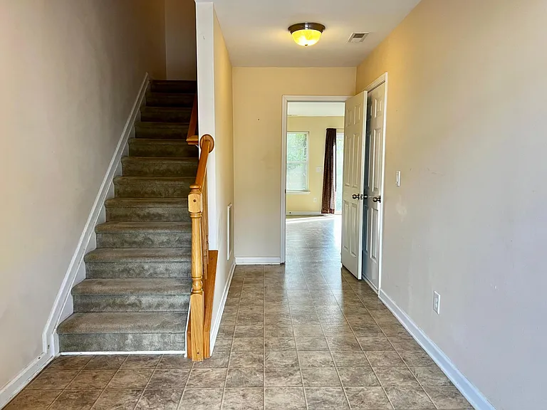 Large entry way with storage closet, access to the garage, and bonus room downstairs