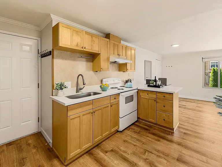 Maple cabinets, quartz countertops, and a new range.