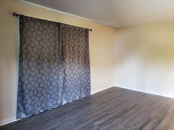 Living room. Beautiful new laminate flooring throughout the unit.