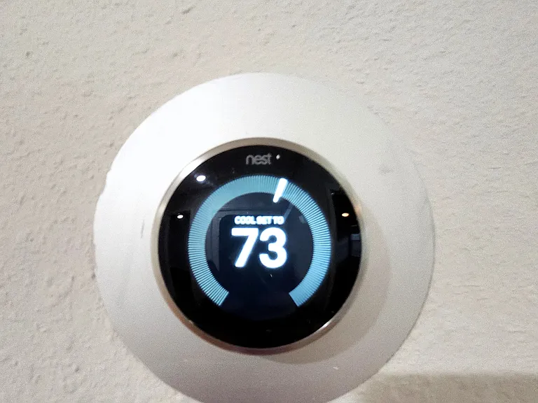 Nest thermostat offers energy-efficient temperature control for the home.