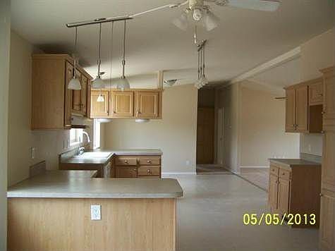 Kitchen looking from breakfast dining area through to other dining area. Living room in to the right