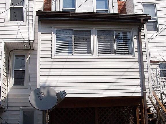 sun room in back with yard and deck