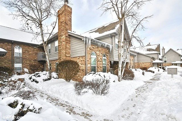 Front walkway leads to white entry door in rear building. The unit includes two parking space #77 & #79, located directly in front.