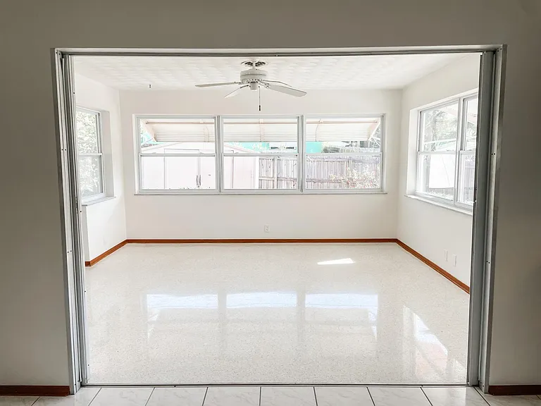 Huge sunroom could easily be a third bedroom. There are sliding doors that could close this room off if desired. This room has a beautiful view into the backyard.