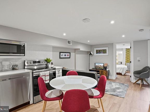 Living space features a full, spacious eat-in kitchen, cozy living room, and space for a desk to work from home