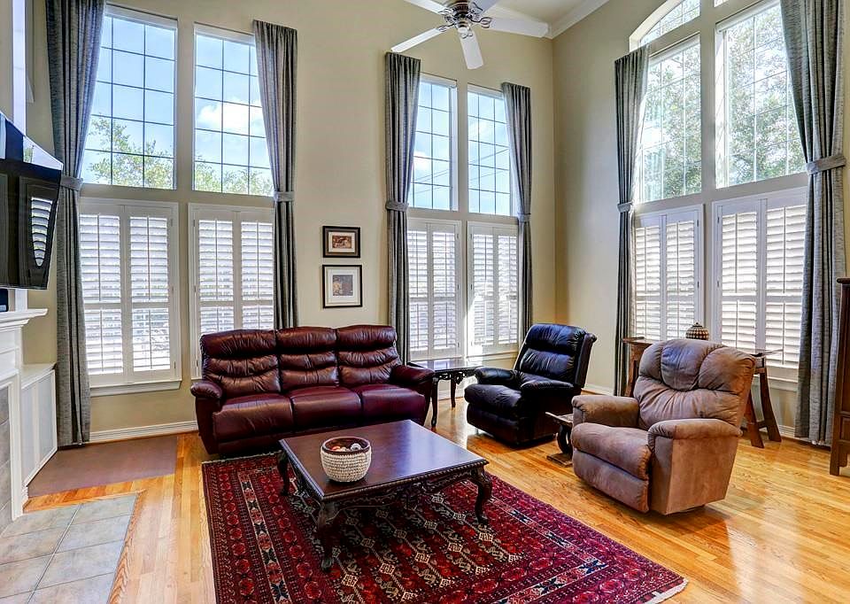 Gracious light filled great room with plantation shutters and hardwood flooring throughout.