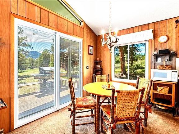 Eating area with view of mountains. BBQ on outside deck.