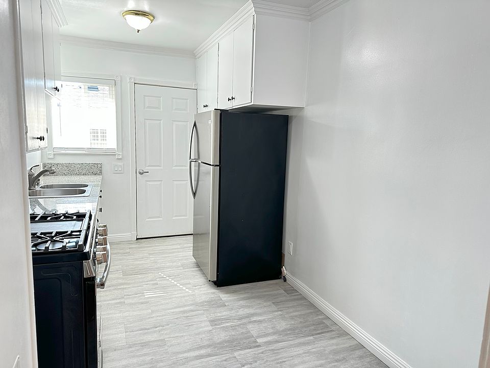 Galley Kitchen with Stainless Steel Refrigerator