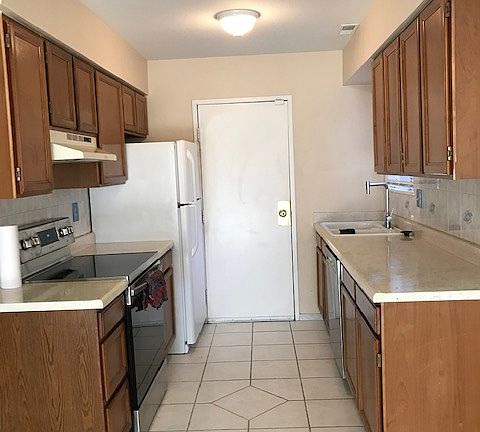Kitchen: Newer electric stove, newer dishwasher, and large fridge