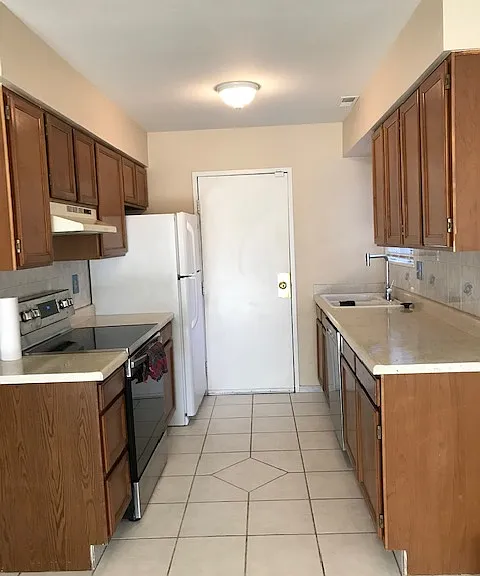 Kitchen: Newer electric stove, newer dishwasher, and large fridge