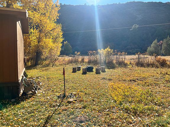 backyard in autumn with view of shared property