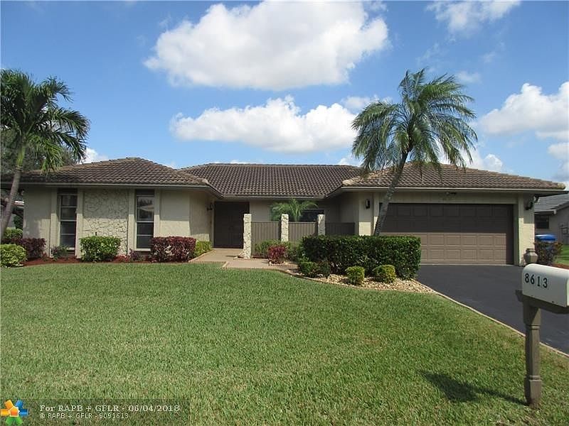 FRONT VIEW  -INTERIOR LOCATION,  ASPHALT DRIVEWAY, BEAUTIFULLY LANDSCAPED