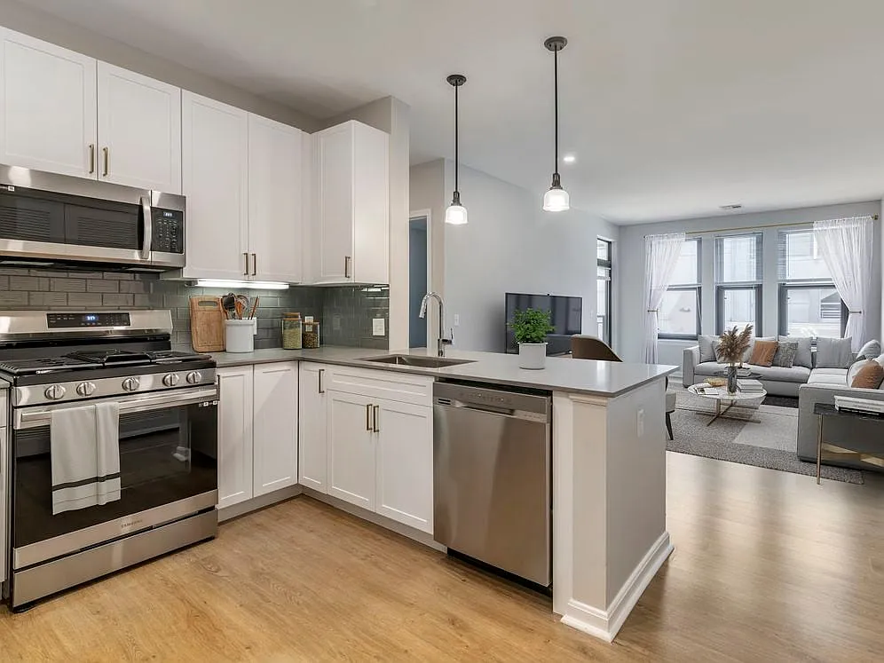 Renovated Package II kitchen and living room with hard surface flooring - Avalon at Assembly Row