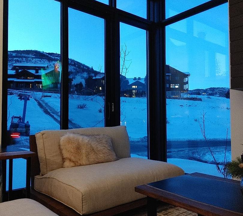 Views during sunset from living room sofa. 4 foot sled chair in velvet from RH gallery