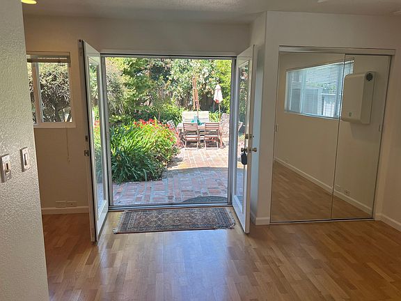French doors open to beautiful brick patio and garden. Kitchen window.