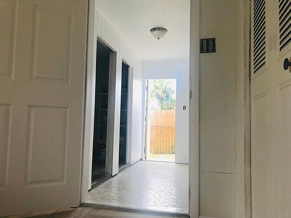 Back hallway exit, entrance to washer/dryer hookup and utility room