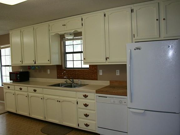 Lots of cabinets, counter space, plus cutting board piece above the dishwasher