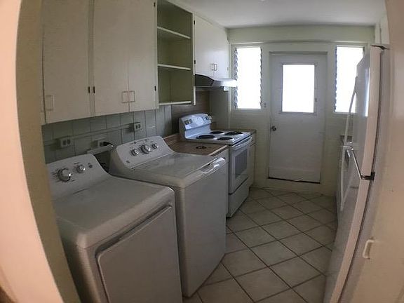 kitchen w/appliances, kitchen door goes to this units taandem parking stalls