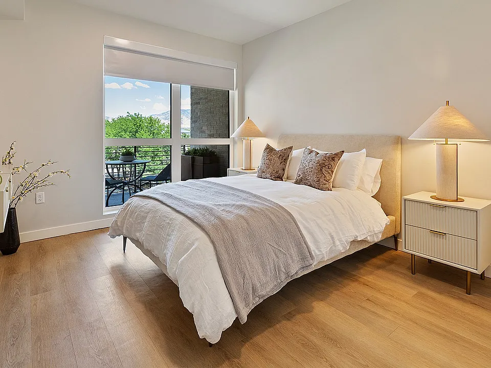 Jade bedroom with large window and neutral tones