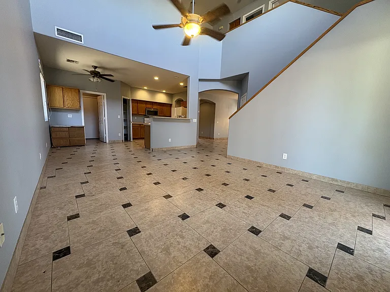 From the kitchen, you can watch the kids as they play in the den or walk out into the back yard.