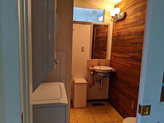 bathroom with shower stall and w/d combo