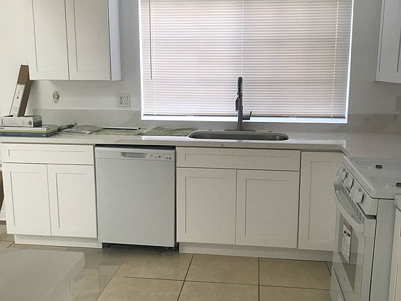 Well-lit kitchen with natural light from large window.